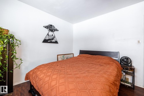 Bedroom featuring dark flooring - 12231 47 Street, Edmonton, AB - Indoor Photo Showing Bedroom