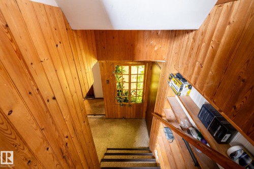Stairs featuring wood walls - 12231 47 Street, Edmonton, AB - Indoor Photo Showing Other Room