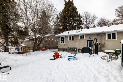 Snow covered house featuring stucco siding and a patio - 12231 47 Street, Edmonton, AB - Outdoor