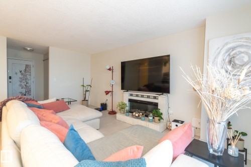 215 13910 Stony Plain Road, Edmonton, AB - Indoor Photo Showing Living Room With Fireplace