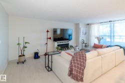 Living area with wood finished floors and baseboards - 