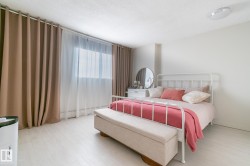 Bedroom with wood finished floors and a textured ceiling - 