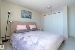 Bedroom with a textured ceiling, a closet, and light wood-type flooring - 