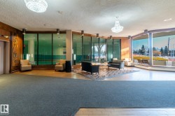 Community lobby featuring a textured ceiling and expansive windows - 