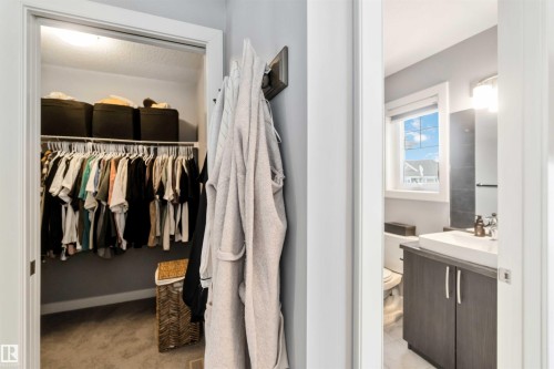 Half bath featuring vanity, a spacious closet, and light colored carpet - 17143 38 Street, Edmonton, AB - Indoor