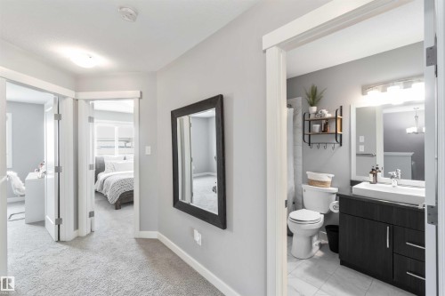 Ensuite bathroom with vanity, curtained shower, and light carpet - 17143 38 Street, Edmonton, AB - Indoor Photo Showing Bathroom
