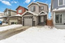 View of front of property featuring concrete driveway and stone siding - 17143 38 Street, Edmonton, AB  - Outdoor With Facade 