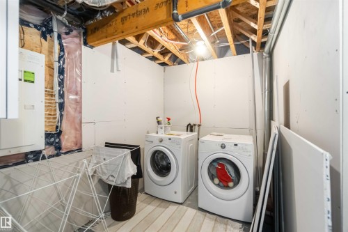 Laundry area featuring electric panel and washer and clothes dryer - 17143 38 Street, Edmonton, AB - Indoor Photo Showing Laundry Room