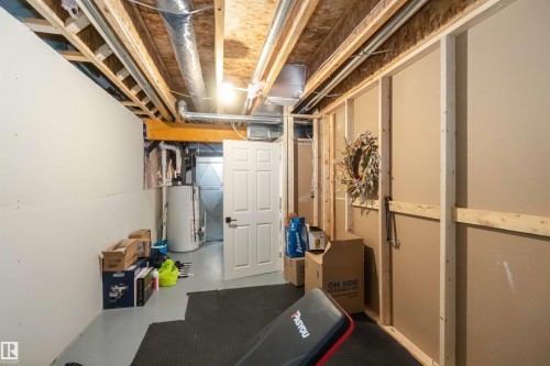 Unfinished basement featuring gas water heater - 17143 38 Street, Edmonton, AB - Indoor Photo Showing Basement