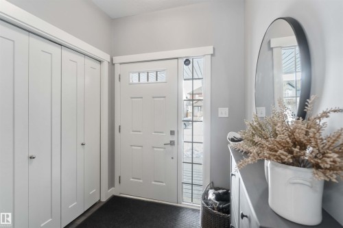 Foyer entrance with dark colored carpet - 17143 38 Street, Edmonton, AB - Indoor Photo Showing Other Room