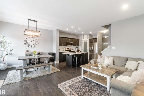Living room featuring dark wood-style flooring and recessed lighting - 17143 38 Street, Edmonton, AB - Indoor Photo Showing Living Room