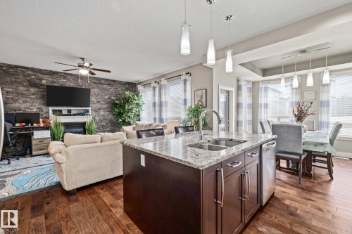 69 Cypress Link, Fort Saskatchewan, AB - Indoor Photo Showing Kitchen With Fireplace With Double Sink