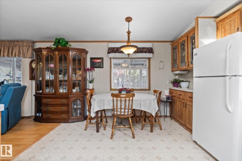 Dining area with light flooring and crown molding - 89-3400 48, Stony Plain, AB - Indoor Photo Showing Dining Room