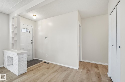 Foyer with light wood-style flooring and a textured ceiling - 12107 53 Street, Edmonton, AB - Indoor Photo Showing Other Room