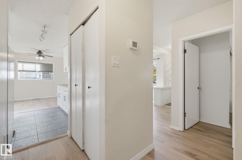 Hall featuring light wood-style floors and a textured ceiling - 12107 53 Street, Edmonton, AB - Indoor Photo Showing Other Room