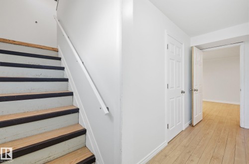 Stairs featuring hardwood / wood-style floors and baseboards - 12107 53 Street, Edmonton, AB - Indoor Photo Showing Other Room