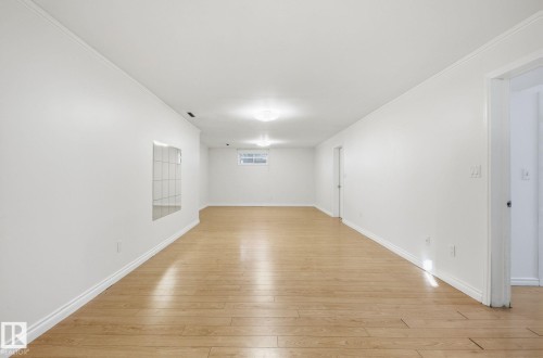 Unfurnished room featuring ornamental molding and light wood-style floors - 12107 53 Street, Edmonton, AB - Indoor Photo Showing Other Room