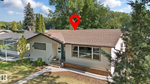 View of front of home featuring a shingled roof and a front lawn - 12107 53 Street, Edmonton, AB - Outdoor