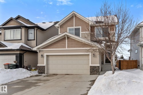 Craftsman-style home featuring stone siding and concrete driveway - 1043 South Creek Wynd, Stony Plain, AB - Outdoor With Facade