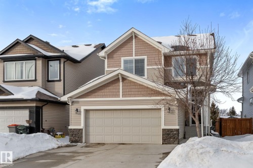 Craftsman house featuring stone siding and concrete driveway - 1043 South Creek Wynd, Stony Plain, AB - Outdoor With Facade