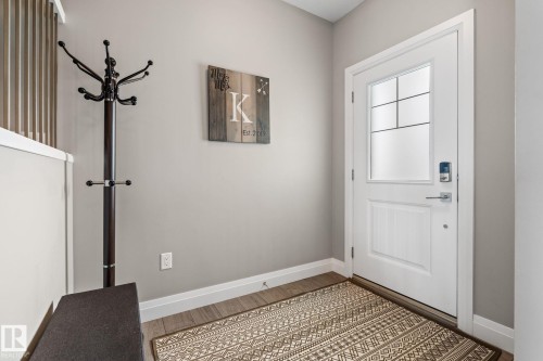 Doorway to outside featuring baseboards and wood finished floors - 1043 South Creek Wynd, Stony Plain, AB - Indoor Photo Showing Other Room