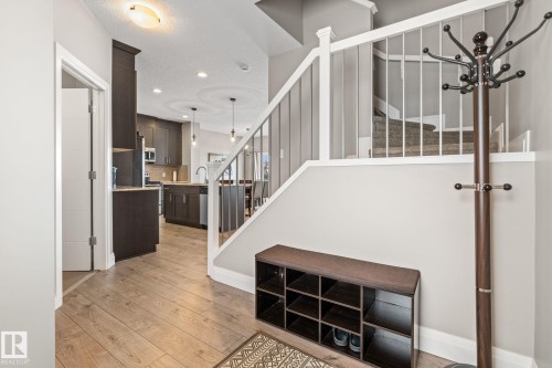 Stairway featuring hardwood / wood-style flooring, recessed lighting, and a textured ceiling - 1043 South Creek Wynd, Stony Plain, AB - Indoor Photo Showing Other Room