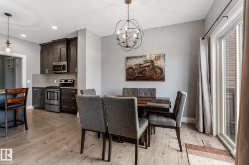 Dining room featuring a chandelier and light wood-type flooring - 1043 South Creek Wynd, Stony Plain, AB - Indoor Photo Showing Other Room