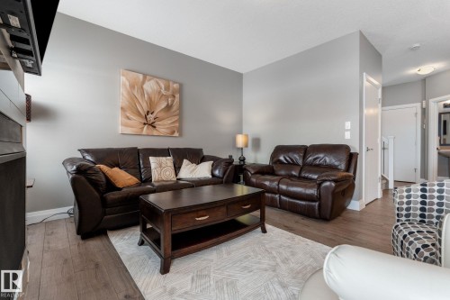 Living area with light wood finished floors and baseboards - 1043 South Creek Wynd, Stony Plain, AB - Indoor Photo Showing Living Room
