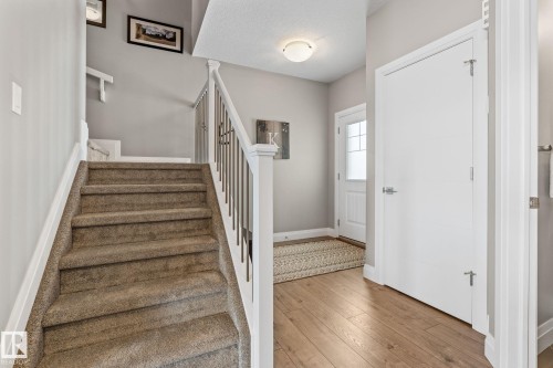 Staircase featuring hardwood / wood-style flooring and baseboards - 1043 South Creek Wynd, Stony Plain, AB - Indoor Photo Showing Other Room