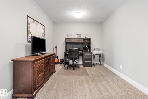 Home office with light carpet and a textured ceiling - 1043 South Creek Wynd, Stony Plain, AB - Indoor Photo Showing Office
