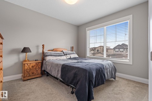 Bedroom featuring baseboards and light colored carpet - 1043 South Creek Wynd, Stony Plain, AB - Indoor Photo Showing Bedroom