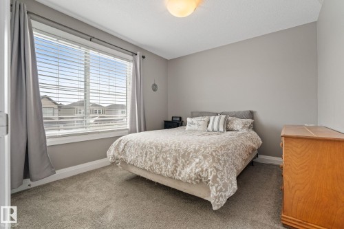 Bedroom with carpet flooring and baseboards - 1043 South Creek Wynd, Stony Plain, AB - Indoor Photo Showing Bedroom