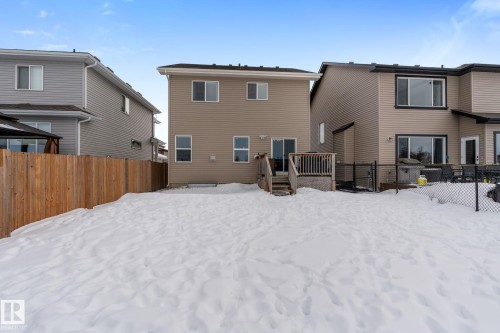 Snow covered back of property with a deck - 1043 South Creek Wynd, Stony Plain, AB - Outdoor With Exterior