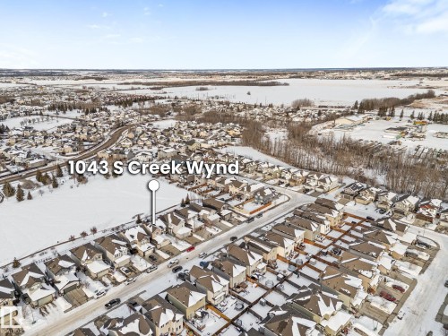 Snowy aerial view featuring a residential view - 1043 South Creek Wynd, Stony Plain, AB - Outdoor With View