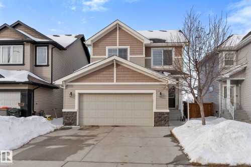 Craftsman-style house with stone siding, a garage, and concrete driveway - 1043 South Creek Wynd, Stony Plain, AB - Outdoor With Facade