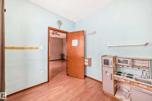 Office area with light wood-style floors, lofted ceiling, and a ceiling fan - 9823 75 Avenue, Edmonton, AB - Indoor