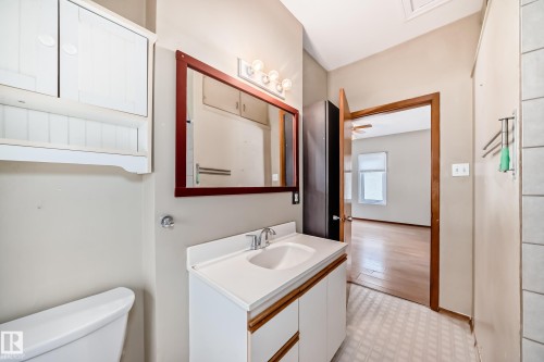 Half bath with vanity and light flooring - 9823 75 Avenue, Edmonton, AB - Indoor Photo Showing Bathroom