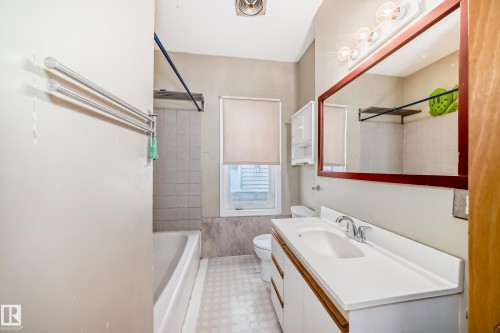 Full bathroom with vanity, light floors, and shower / tub combination - 9823 75 Avenue, Edmonton, AB - Indoor Photo Showing Bathroom