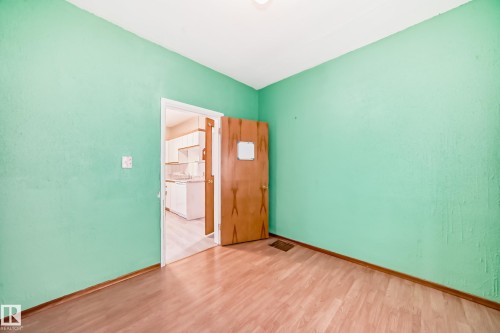 Unfurnished room featuring light wood-style floors and baseboards - 9823 75 Avenue, Edmonton, AB - Indoor Photo Showing Other Room