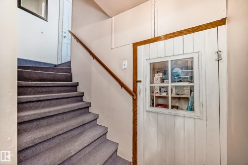 Staircase featuring wood walls - 9823 75 Avenue, Edmonton, AB - Indoor Photo Showing Other Room