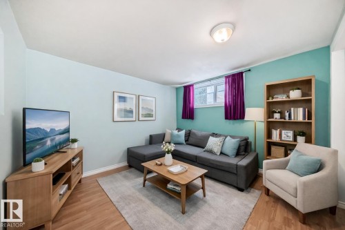 Living room with light wood-type flooring and baseboards - 9823 75 Avenue, Edmonton, AB - Indoor Photo Showing Living Room