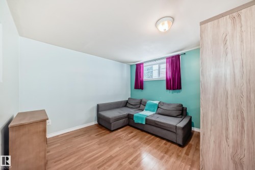 Sitting room featuring light wood-style flooring and baseboards - 9823 75 Avenue, Edmonton, AB - Indoor