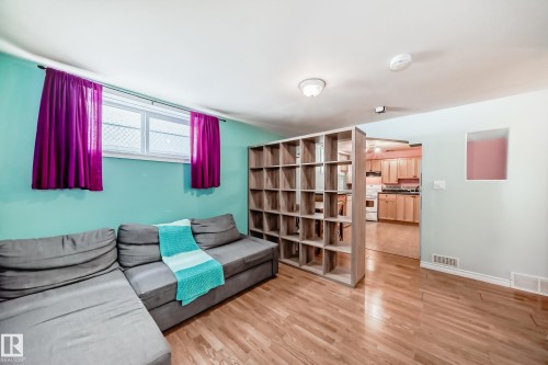 Sitting room featuring light wood-style flooring and baseboards - 9823 75 Avenue, Edmonton, AB - Indoor