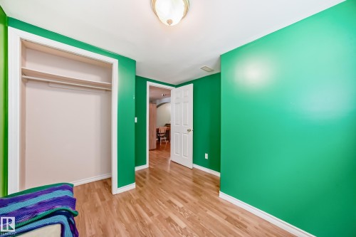 Unfurnished bedroom with light wood-style flooring and a closet - 9823 75 Avenue, Edmonton, AB - Indoor