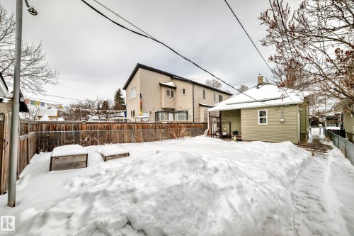 Snow covered rear of property with a fenced backyard and a chimney - 9823 75 Avenue, Edmonton, AB - Outdoor