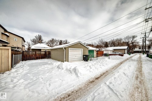 Snow covered garage with a garage - 9823 75 Avenue, Edmonton, AB - Outdoor