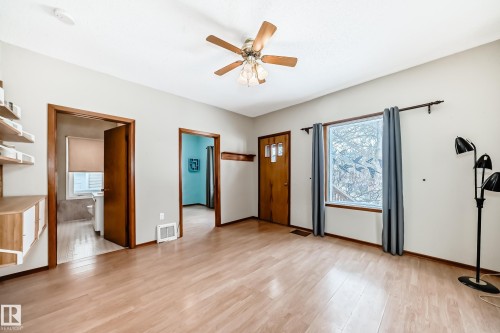 Entrance foyer with a ceiling fan and light wood-style floors - 9823 75 Avenue, Edmonton, AB - Indoor Photo Showing Other Room