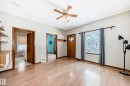 Entrance foyer with a ceiling fan and light wood-style floors - 9823 75 Avenue, Edmonton, AB  - Indoor Photo Showing Other Room 