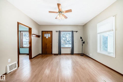 Entrance foyer featuring light wood-type flooring, ceiling fan, and healthy amount of natural light - 9823 75 Avenue, Edmonton, AB - Indoor Photo Showing Other Room