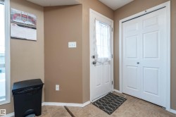 Entrance foyer with light tile patterned floors and a textured ceiling - 